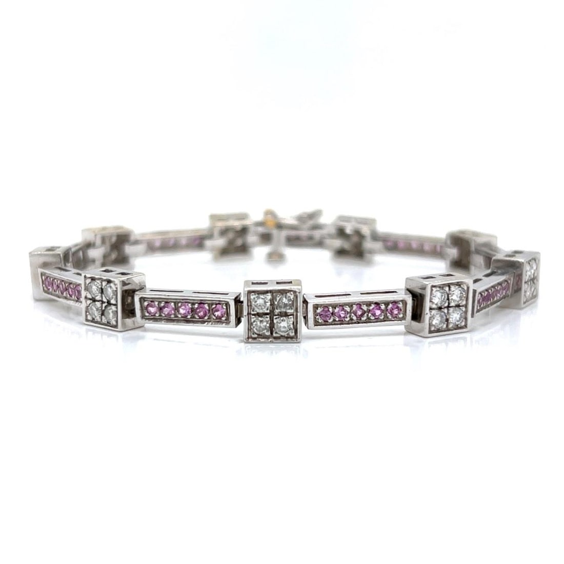 Diamond and Pink Sapphire Bracelet in 14K White Gold 6.75 Inch: Diamond and Pink Sapphire Bracelet in 14K White Gold 6.75 Inch This 14K white gold bracelet features 36 diamonds totaling approximately 2.15 carats with F-G color and VS1-VS2 clarity, complemented by 