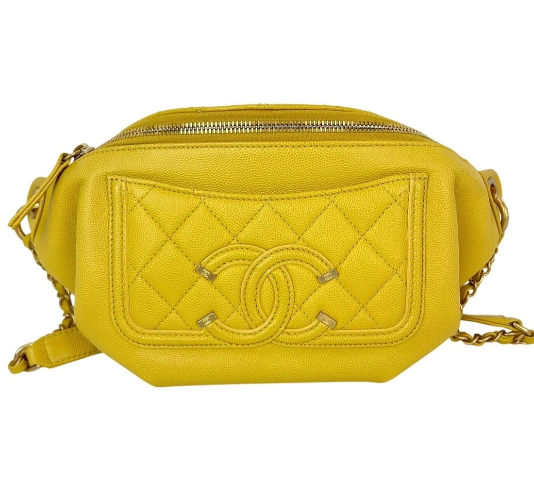 Chanel Yellow Caviar Leather Crescent Belt Bag: Chanel Yellow Caviar Leather Crescent Belt Bag This Chanel Caviar Quilted Filigree Waist Bag features a crescent shape with a quilted argyle/diamond pattern in yellow leather. The bag is designed with