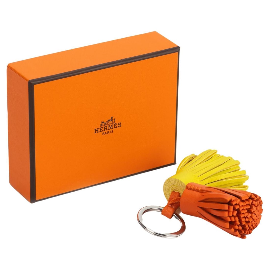 Hermes Carmen Double Keychain Lime Feu Leather Pom Pom: Hermes Carmen Double Keychain Lime Feu Leather Pom Pom This exquisite Hermes Carmen Double Keychain is a designer accessory crafted from premium lime and feu leather, featuring elegant palladium hardw