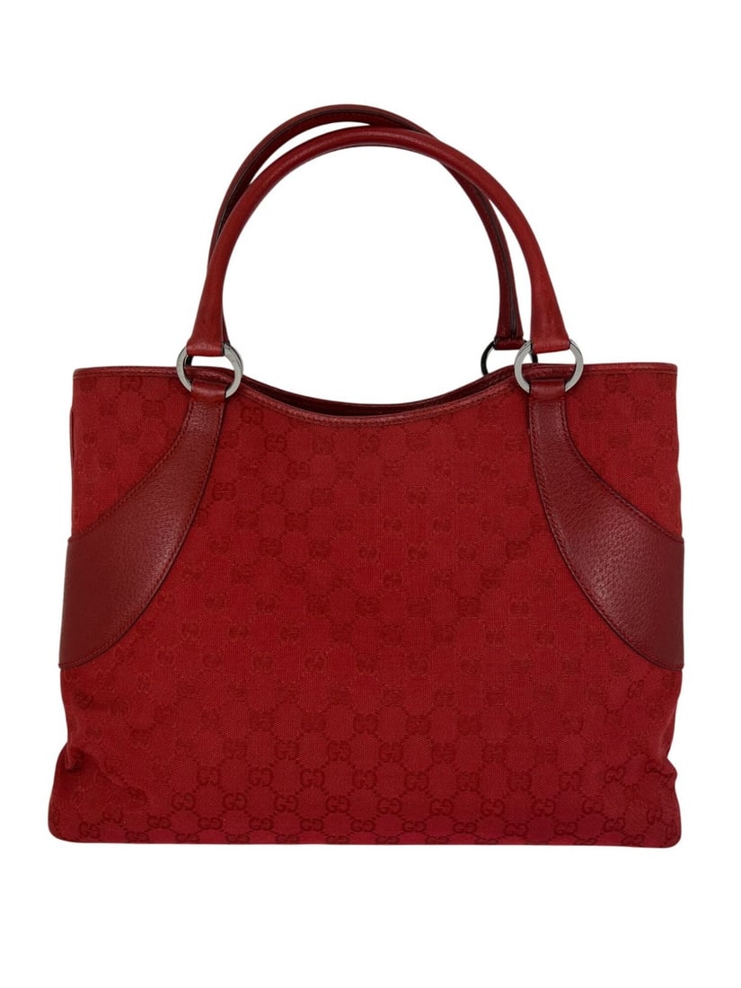Gucci Red GG Canvas Medium Tote with Double Handles: Gucci Red GG Canvas Medium Tote with Double Handles This Gucci GG Canvas Red Shoulder Tote Bag features a rectangular shape crafted from signature Gucci GG canvas with red leather double handles. It i