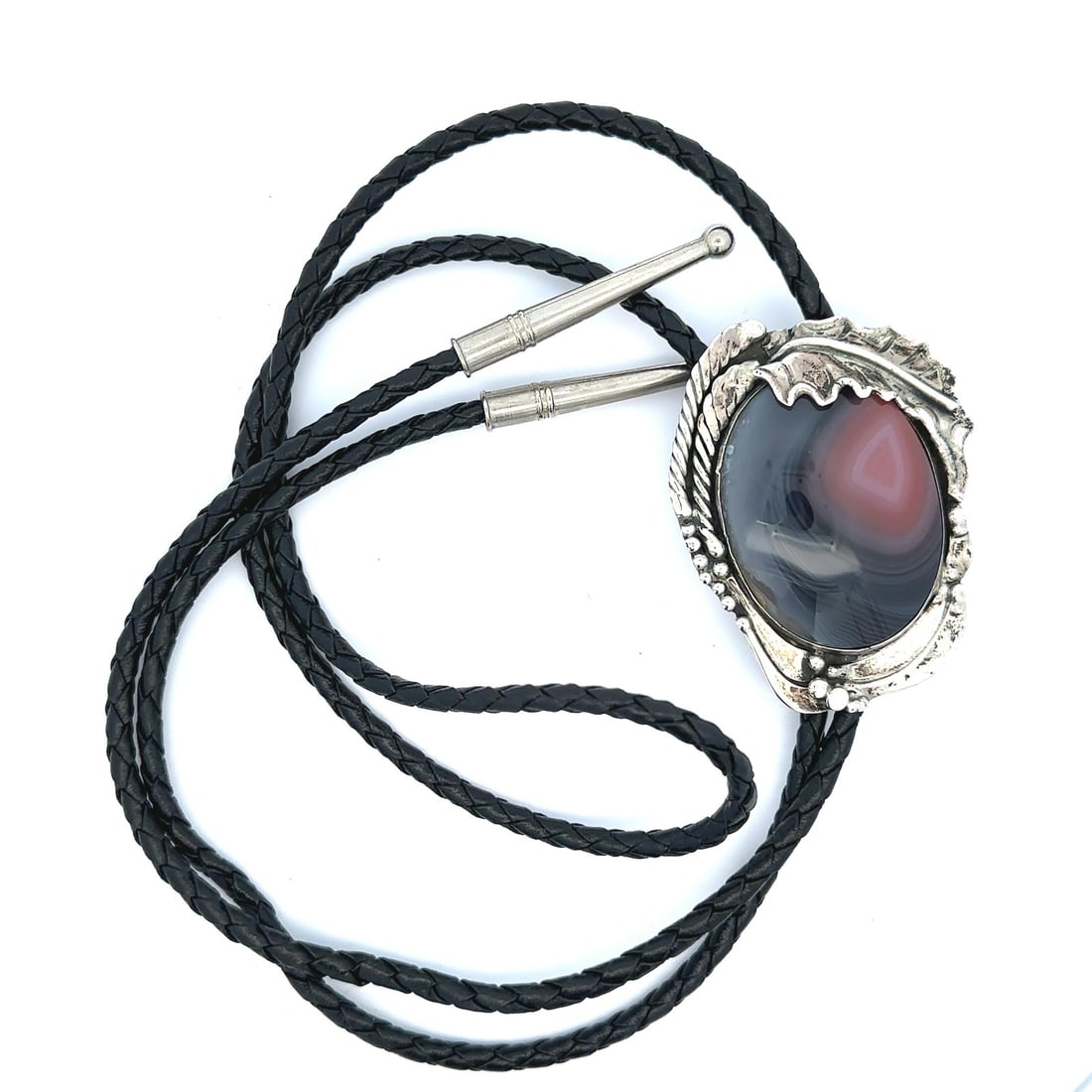 Sterling Silver Bolo Tie with Purple Pink Agate on Black Leather by Stan Davidson: Sterling Silver Bolo Tie with Purple Pink Agate on Black Leather by Stan Davidson This bolo tie features a natural banded agate cabochon with a gradient of dark purple to medium pink hues, bezel set i
