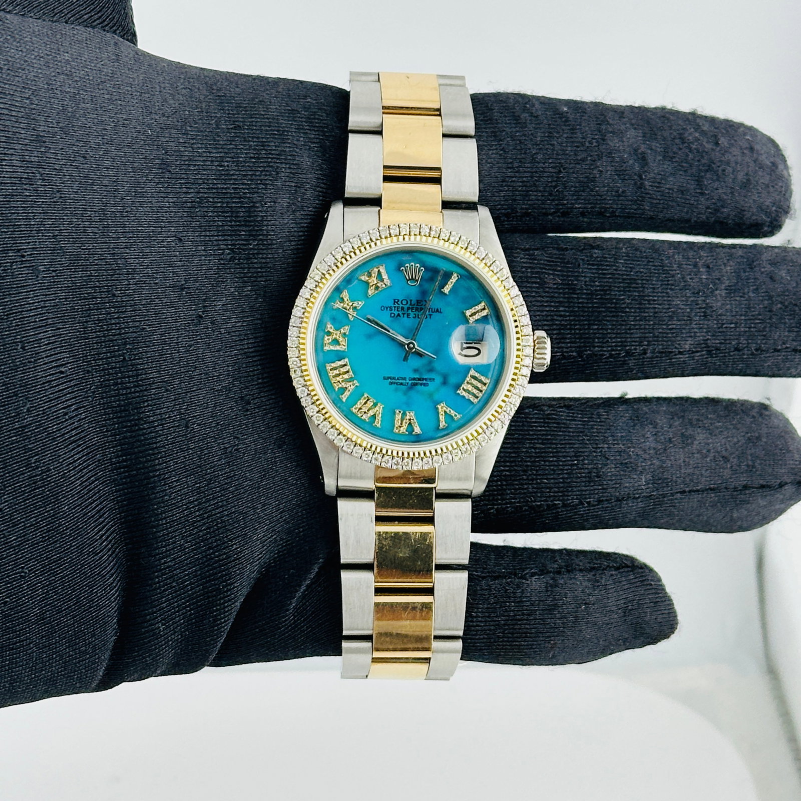 Rolex Mens Aftermarket Turquoise Roman Dial Datejust Ref 1601 Oyster Bracelet: Rolex Mens Aftermarket Turquoise Roman Dial Datejust Ref 1601 Oyster Bracelet This Rolex Datejust watch features an Aftermarket turquoise Roman numeral dial, complemented by a prong plated bezel and a
