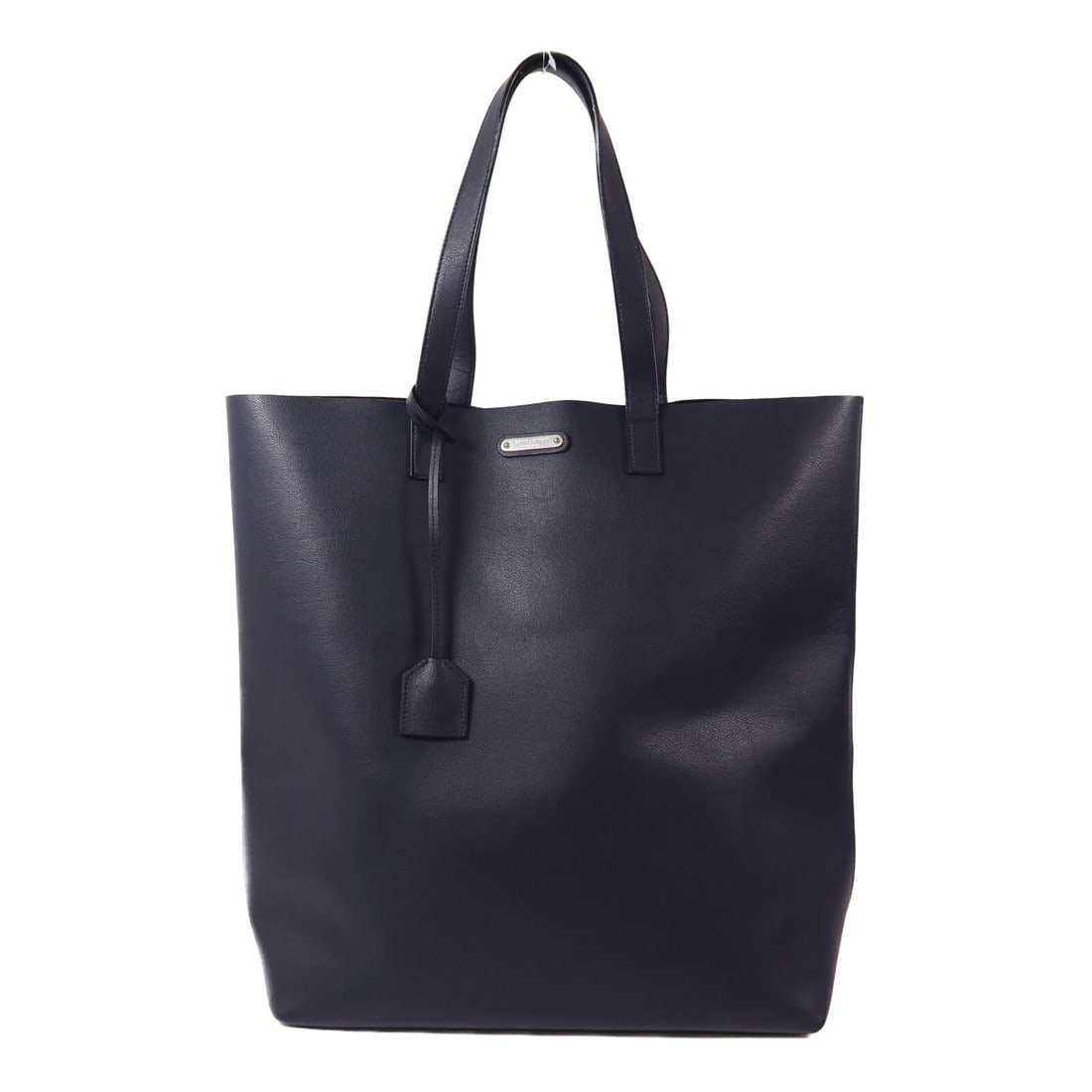 Yves Saint Laurent Calfskin Navy Tote with Silver Hardware: Yves Saint Laurent Calfskin Navy Tote with Silver Hardware This Saint Laurent tote bag is crafted from navy calfskin leather and designed for women. It features a spacious interior and is sized for re
