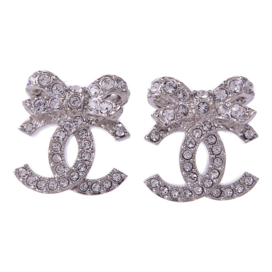 CHANEL Silver CC Pierced Earrings: CHANEL Silver CC Pierced Earrings These CHANEL CC pierced earrings feature a clear design with silver-toned metal accents. Crafted in France, they are designed for women and do not include any main st