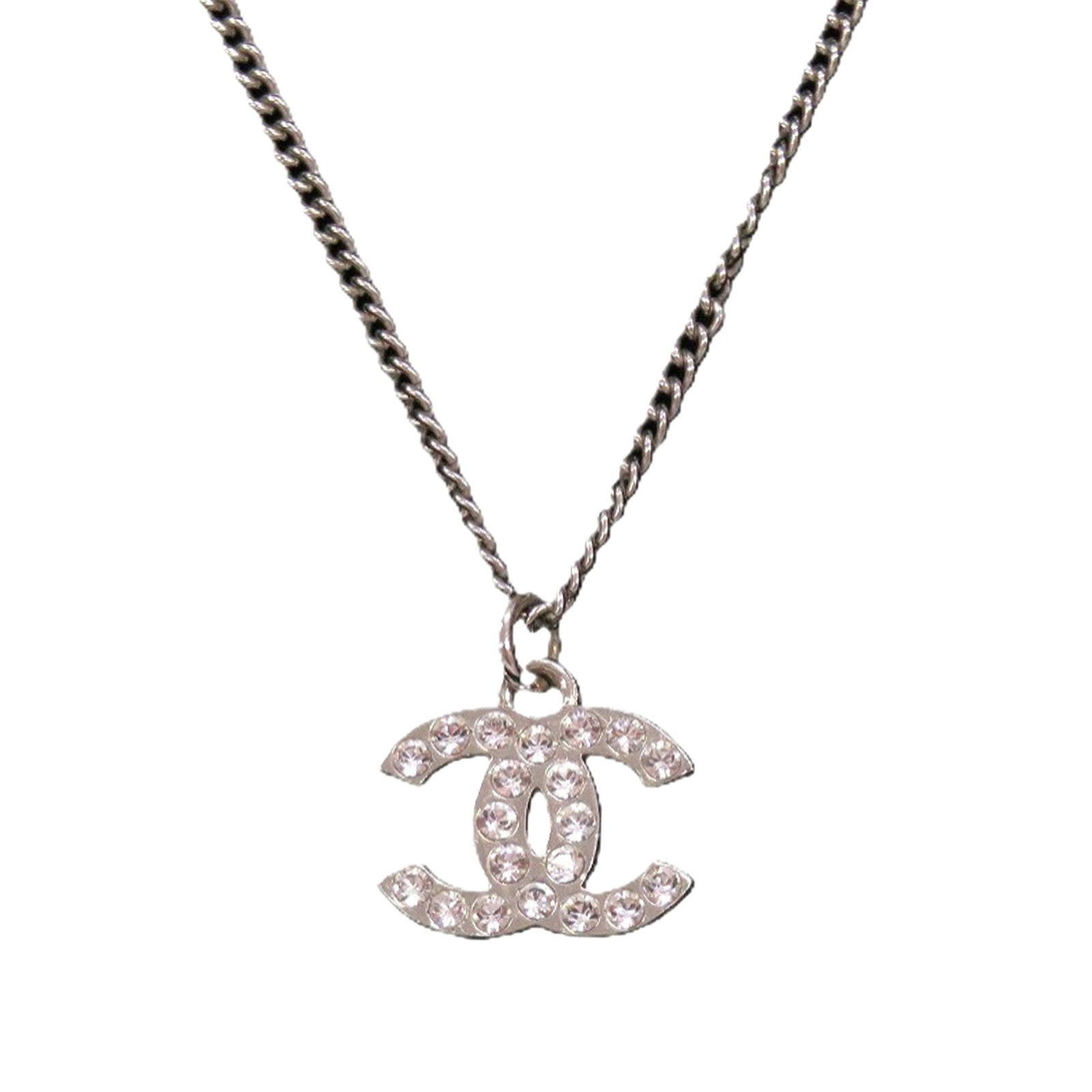 Chanel Silver Tone CC Pendant Necklace Brass Strass: Chanel Silver Tone CC Pendant Necklace Brass Strass This Chanel CC Brass and Strass Pendant Necklace features a silver-tone metal construction adorned with rhinestone embellishments. The necklace is s