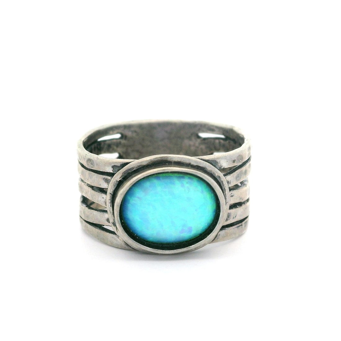 Vintage Sterling Silver Hammered Cocktail Ring with Blue Opal: Vintage Sterling Silver Hammered Cocktail Ring with Blue Opal This vintage cocktail ring showcases a stunning synthetic opal, featuring an oval cabochon shape and a beautiful blue base with vibrant gr