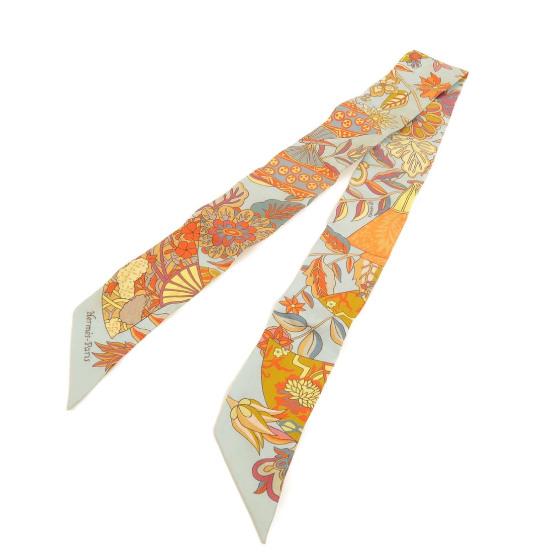Hermes silk Twilly scarf blue orange: Hermes silk Twilly scarf blue orange This Hermes Twilly scarf is crafted from luxurious silk and features a striking blue and orange color palette. Designed for women, it offers a versatile accessory 
