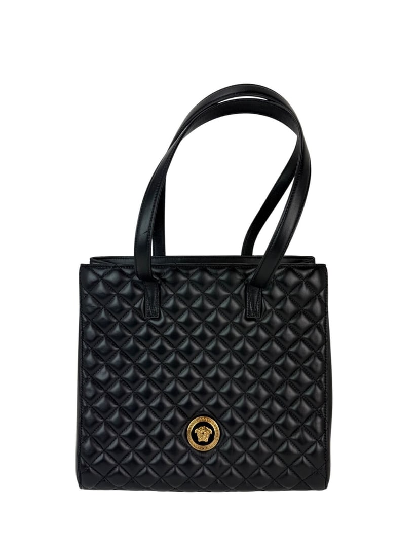 Versace Gianni Medusa Quilted Black Leather Tote Bag: Versace Gianni Medusa Quilted Black Leather Tote Bag Elevate your style with the Versace Gianni Nappa Quilted Medusa Black Leather Tote Bag. This medium-sized tote features a sophisticated trapezoid s