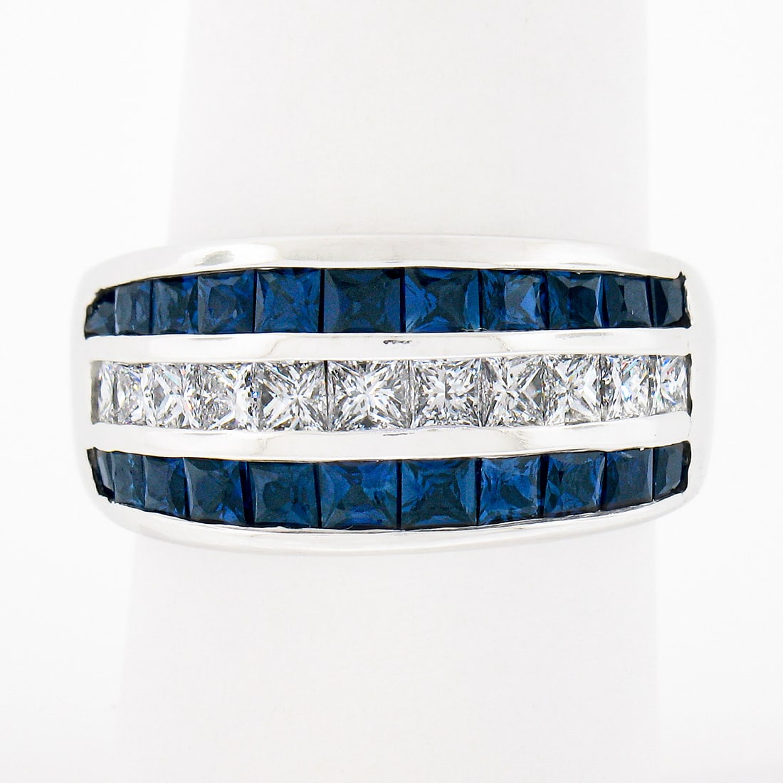 18k White Gold 3.20ctw Channel Set Diamond Sapphire Band Ring: 18k White Gold 3.20ctw Channel Set Diamond Sapphire Band Ring This stunning wide band ring is expertly crafted from solid 18k white gold, showcasing a magnificent multi-row design. The centerpiece fea