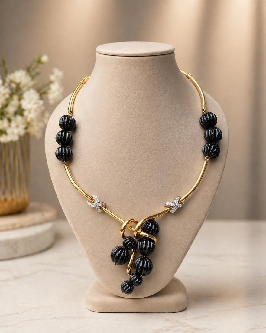 18K Gold Onyx Bead Necklace with Diamond X Links: 18K Gold Onyx Bead Necklace with Diamond X Links This elegant necklace features carved ball beads of natural black onyx, each ranging from approximately 10mm to 15mm, alternating with "X" links crafte