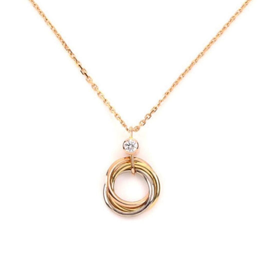 Cartier Trinity 18k Tri Color Gold Diamond Pendant Necklace with Certificate: Cartier Trinity 18k Tri Color Gold Diamond Pendant Necklace with Certificate This Cartier Trinity pendant necklace features the iconic triple rolling rings crafted in solid 18k yellow, white, and rose