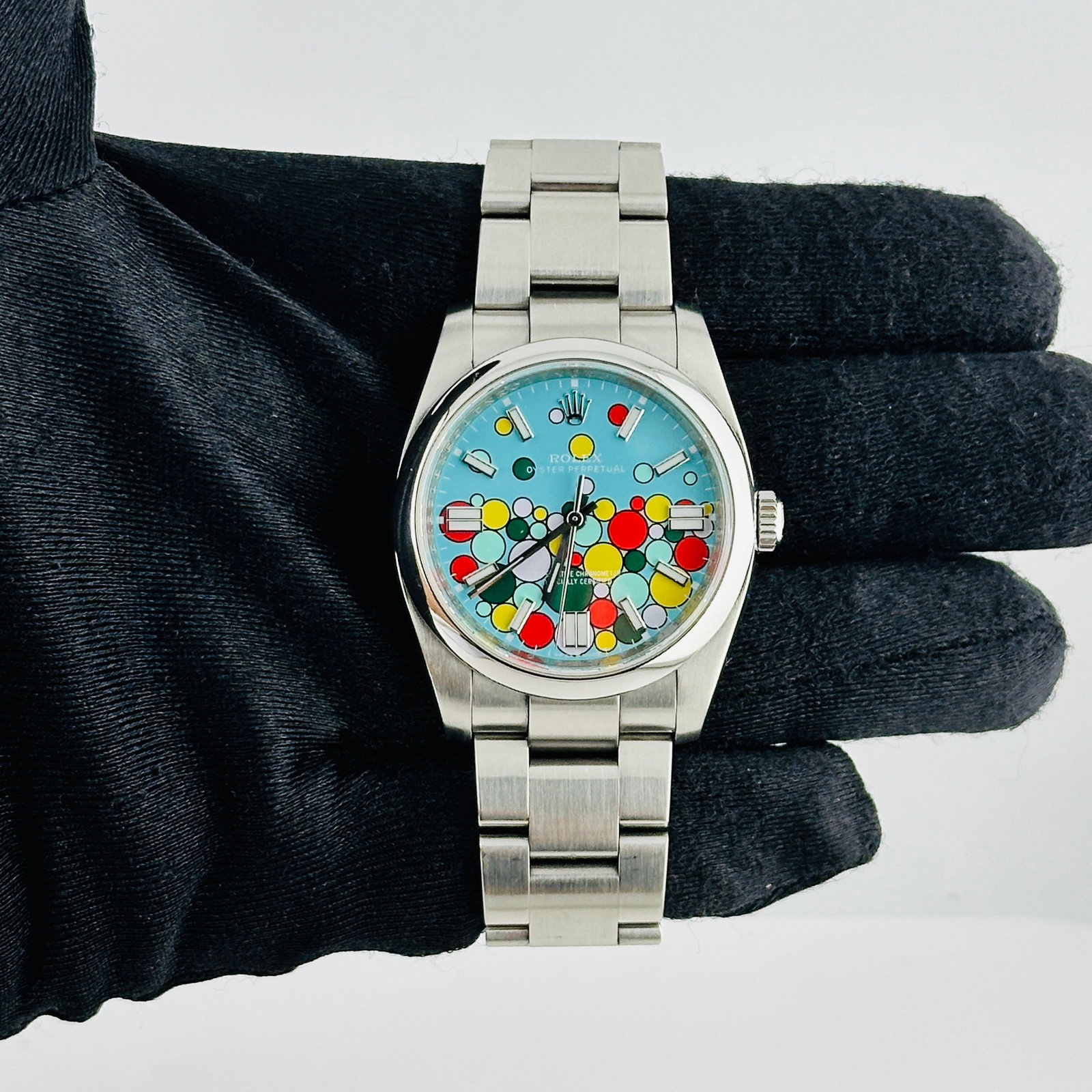 Rolex Oyster Perpetual Celebration Dial Oyster Bracelet Ref 116000: Rolex Oyster Perpetual Celebration Dial Oyster Bracelet Ref 116000 This Rolex Oyster Perpetual features the Aftermarket Celebration dial and is paired with the classic Oyster bracelet. The watch has a