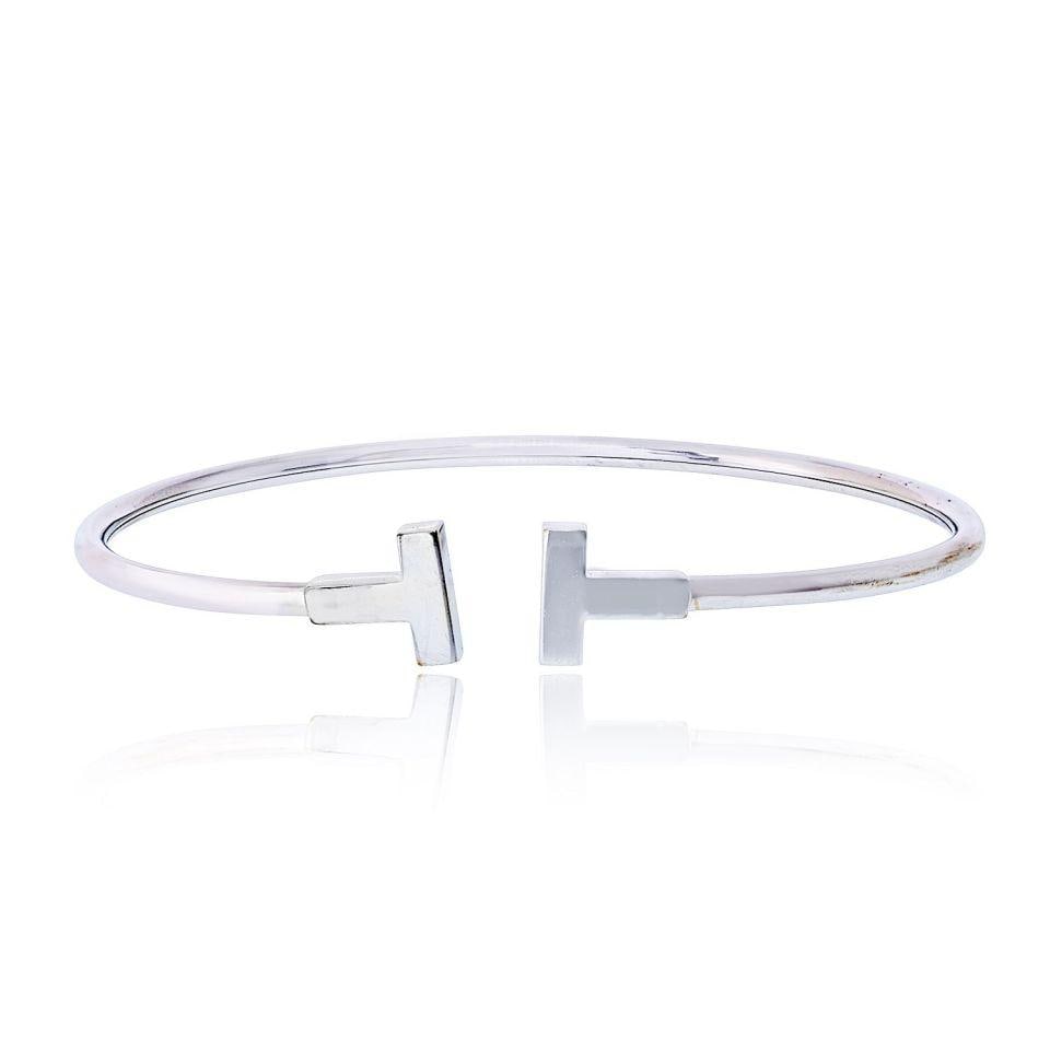 Tiffany & Co T Collection 18K White Gold Bangle Bracelet: Tiffany & Co T Collection 18K White Gold Bangle Bracelet This Tiffany & Co. "T" Collection bangle bracelet is crafted from 18K white gold and features a sleek, classic design. The bracelet is in very 