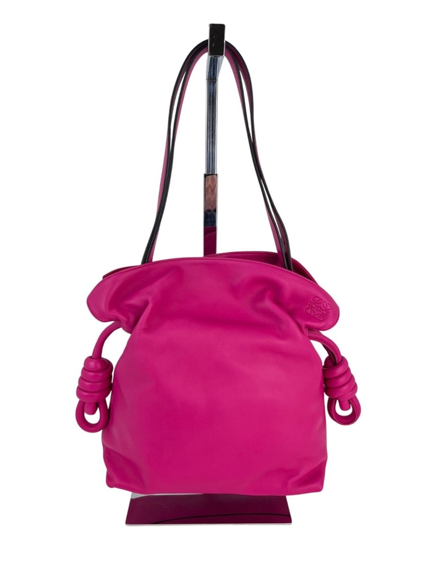 Loewe Flamenco Medium Pink Nappa Leather Shoulder Bag with Knot Detail: Loewe Flamenco Medium Pink Nappa Leather Shoulder Bag with Knot Detail This Loewe Flamenco Medium Knot shoulder bag is crafted from pink nappa leather with a matte finish. It features a trapezoid shap