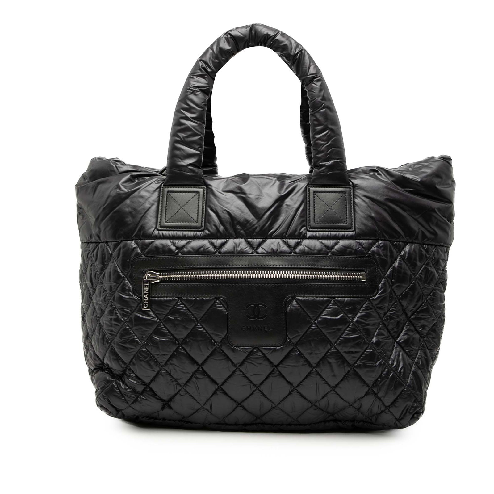Chanel Coco Cocoon black nylon tote with rolled handles: Chanel Coco Cocoon black nylon tote with rolled handles This Chanel Medium Quilted Nylon Reversible Coco Cocoon Tote features a black nylon leather body with a quilted design, rolled handles, and an o