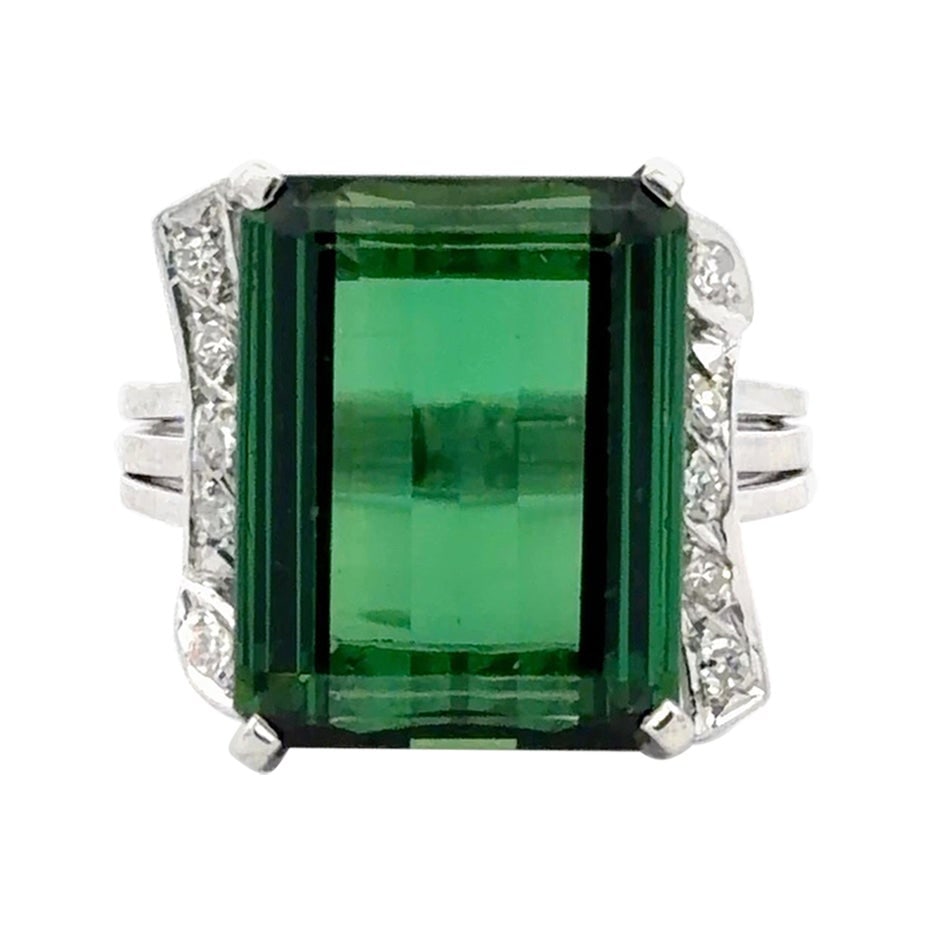 Emerald Cut Green Tourmaline and Diamond Ring in 18K White Gold GIA Certified: Emerald Cut Green Tourmaline and Diamond Ring in 18K White Gold GIA Certified This striking statement ring features a GIA certified emerald-cut green tourmaline weighing approximately 13.00 carats as 