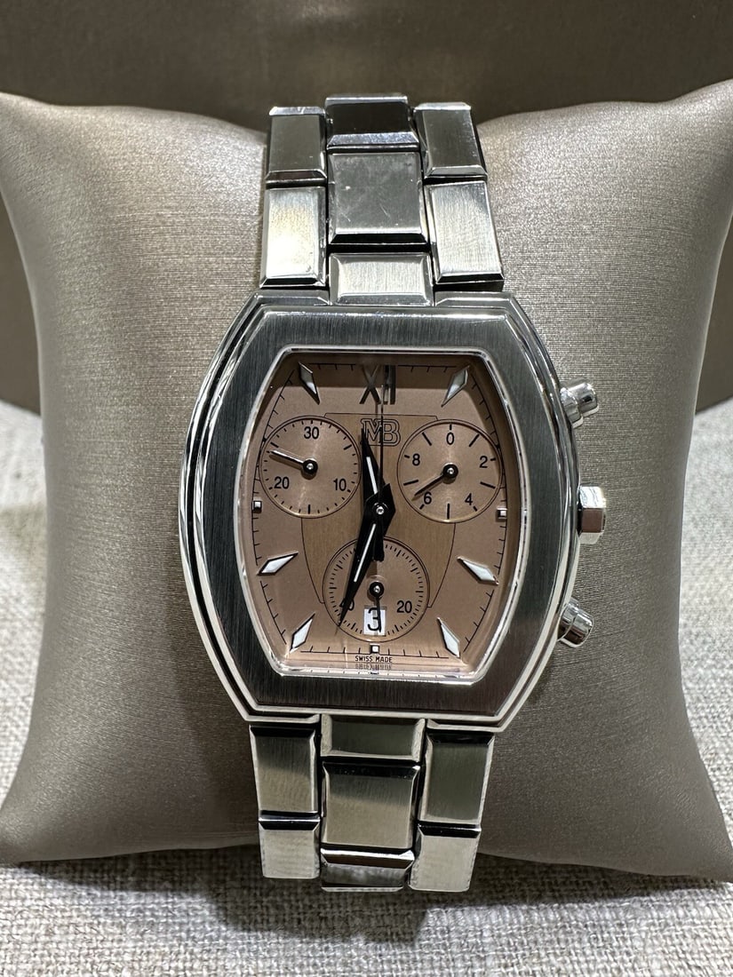 Marina B Nomade Salmon Dial Stainless Steel Chronograph Unisex Watch: Marina B Nomade Salmon Dial Stainless Steel Chronograph Unisex Watch This unisex MB Marina B Nomade wristwatch features a striking salmon dial complemented by a stainless steel case and bracelet. The 