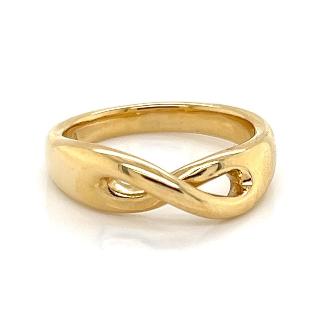 Tiffany & Co Infinity open crossover ring 18k yellow gold size 4.5: Tiffany & Co Infinity open crossover ring 18k yellow gold size 4.5 This Tiffany & Co. Infinity ring is crafted from solid 18k yellow gold and features a graceful open crossover design, symbolizing con