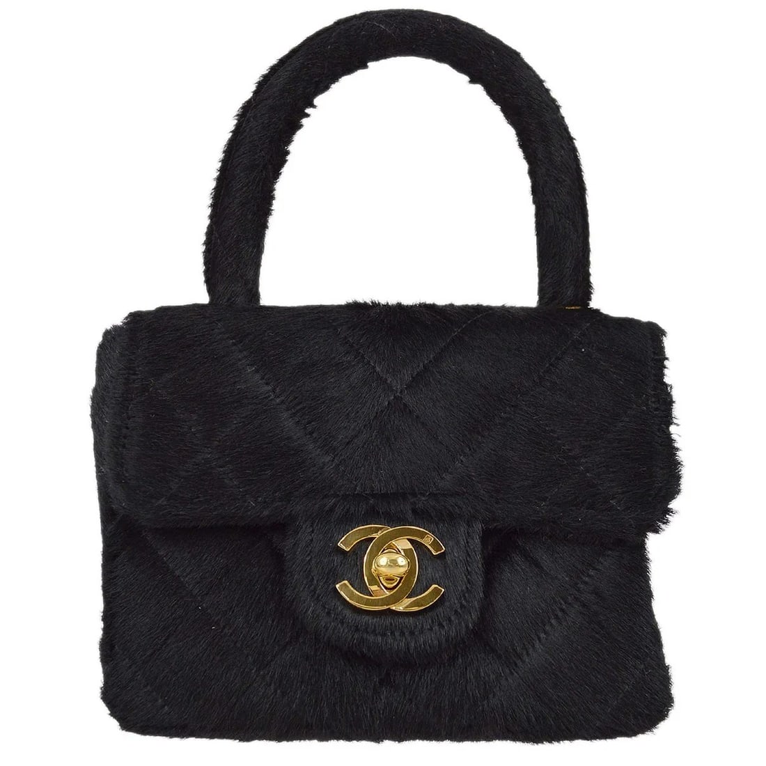 Chanel Micro Top Handle Bag in Black Pony Hair with Logo Accent: Chanel Micro Top Handle Bag in Black Pony Hair with Logo Accent This Chanel Classic Flap micro handbag features a black pony hair exterior and iconic logo accents. Designed in a top handle style, the 