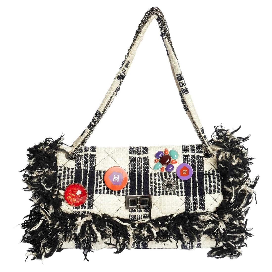 Chanel 2006/2007 Black White Fringe Shoulder Bag with CC Ornaments: Chanel 2006/2007 Black White Fringe Shoulder Bag with CC Ornaments Experience the elegance of this Chanel Fringe Bag, a stunning blend of black and white tweed. This shoulder bag features beautifully 