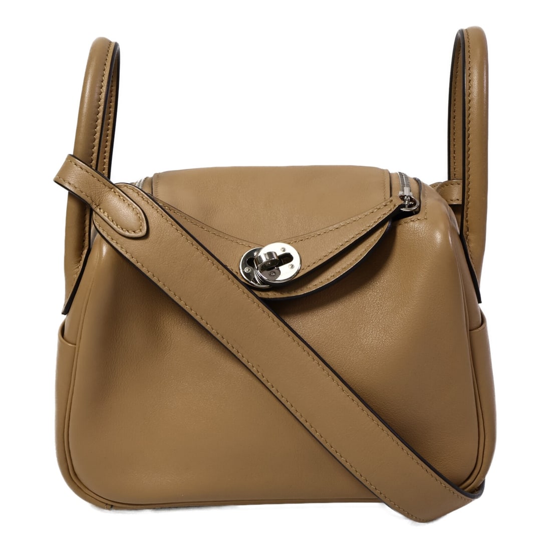 Hermes Mini Lindy Swift Leather 2 Way Shoulder Bag: Hermes Mini Lindy Swift Leather 2 Way Shoulder Bag This HERMES Mini Lindy 2-way shoulder bag is crafted from Swift leather in a sophisticated Chai and Mauve Sylvst color combination. Designed for vers