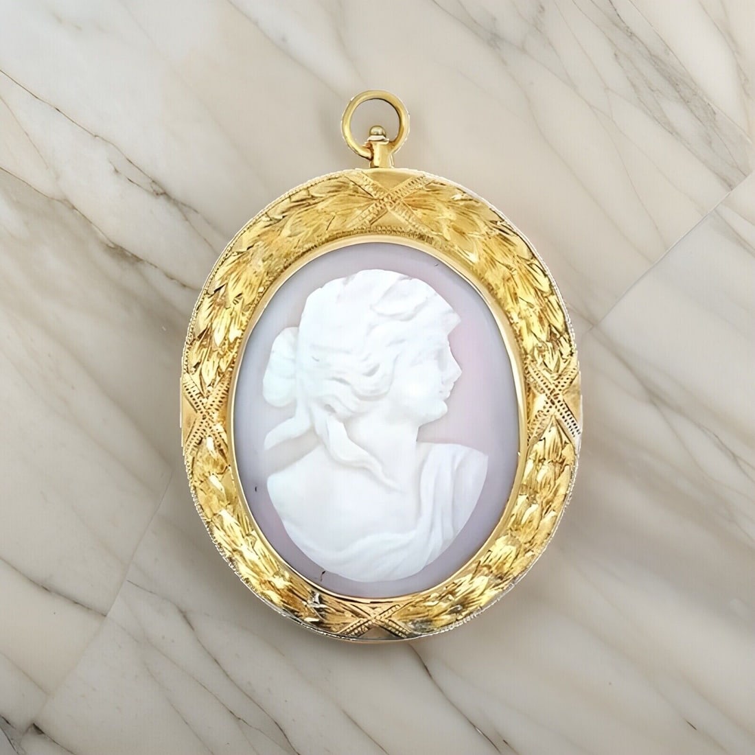 Vintage 14K Yellow Gold Oval Hardstone Brooch Pendant: Vintage 14K Yellow Gold Oval Hardstone Brooch Pendant This exquisite vintage brooch pendant features a beautifully carved oval hardstone set in a 14K yellow gold frame. The intricate hand engraving ad