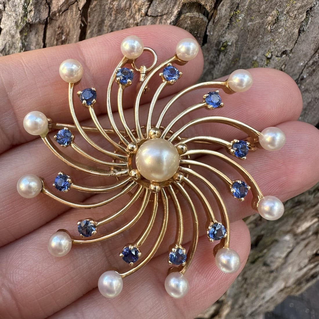 14k Yellow Gold Sapphire Pearl Spiral Brooch Pendant GIA Certified: 14k Yellow Gold Sapphire Pearl Spiral Brooch Pendant GIA Certified This vintage brooch pendant features a striking spiral design crafted from solid 13-14k yellow gold. The piece is adorned with 12 nat