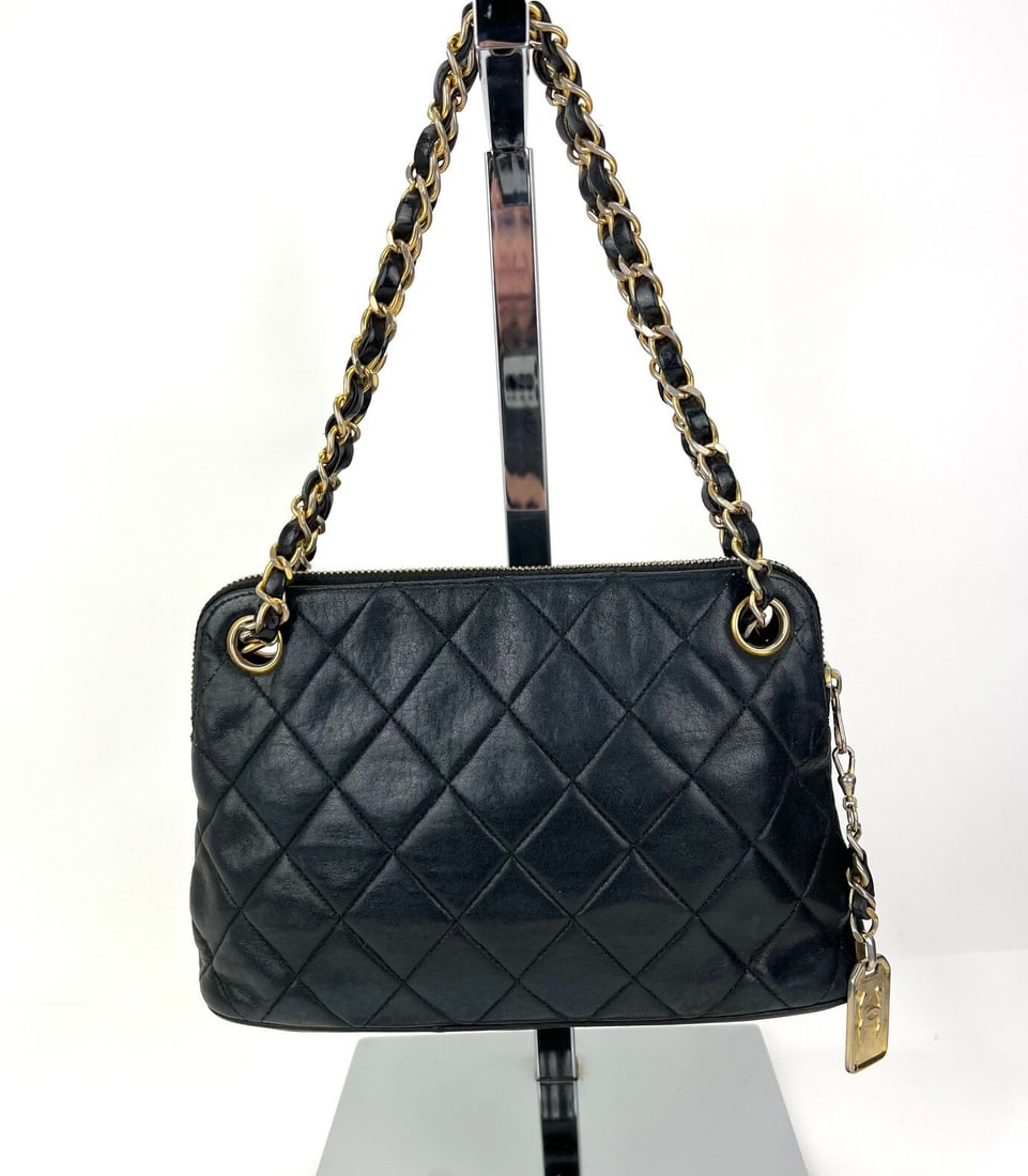 CHANEL Mini Quilted Lambskin Leather Black Shoulder Bag 24K Gold Tone: CHANEL Mini Quilted Lambskin Leather Black Shoulder Bag 24K Gold Tone This elegant CHANEL Mini Shoulder Bag is crafted from premium quilted lambskin leather, showcasing a classic black exterior. Perfe