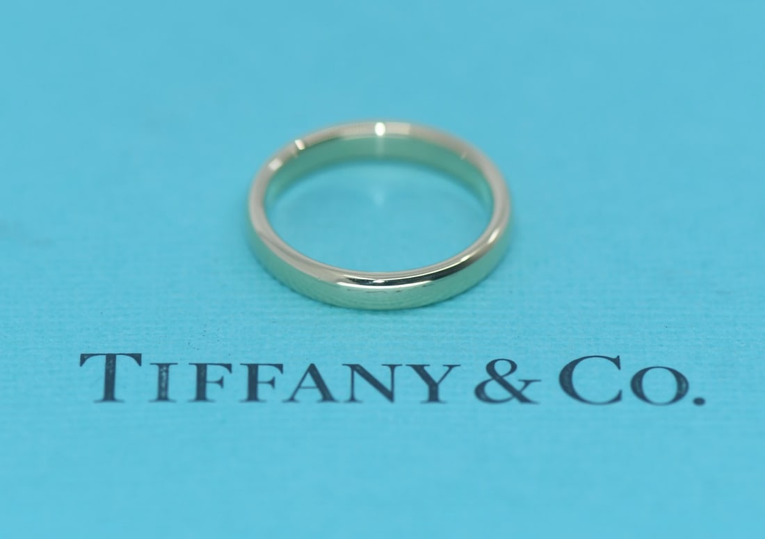 18k Yellow Gold Ring by Tiffany & Co Size 4.5 with Pouch: 18k Yellow Gold Ring by Tiffany & Co Size 4.5 with Pouch This Tiffany & Co. ring is crafted from 18K yellow gold and features a classic, minimalist design. The ring is a size 4.5, measures 3mm in widt