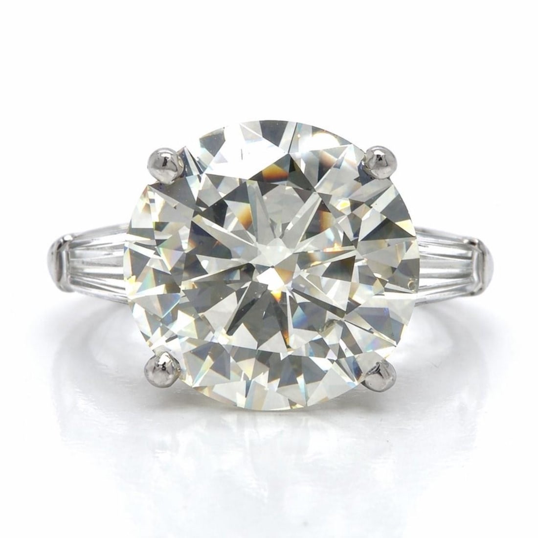 Platinum Art Deco Diamond Ring Featuring 6.97 Carat Center Stone: Platinum Art Deco Diamond Ring Featuring 6.97 Carat Center Stone This Art Deco platinum ring features a central 6.97 carat diamond with M color and VVS1 clarity, measuring 12.82 x 7.30 mm. The ring is