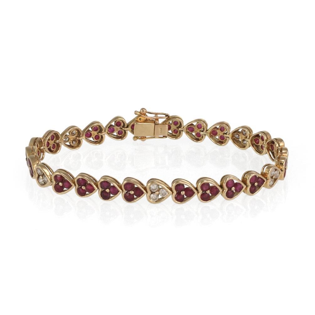 14k Yellow Gold Heart Link Bracelet with 0.50ct Diamonds and 4.00ct Rubies: 14k Yellow Gold Heart Link Bracelet with 0.50ct Diamonds and 4.00ct Rubies This elegant heart link bracelet is crafted from 14k yellow gold and features a unique design with 27 heart-shaped frames. Ou