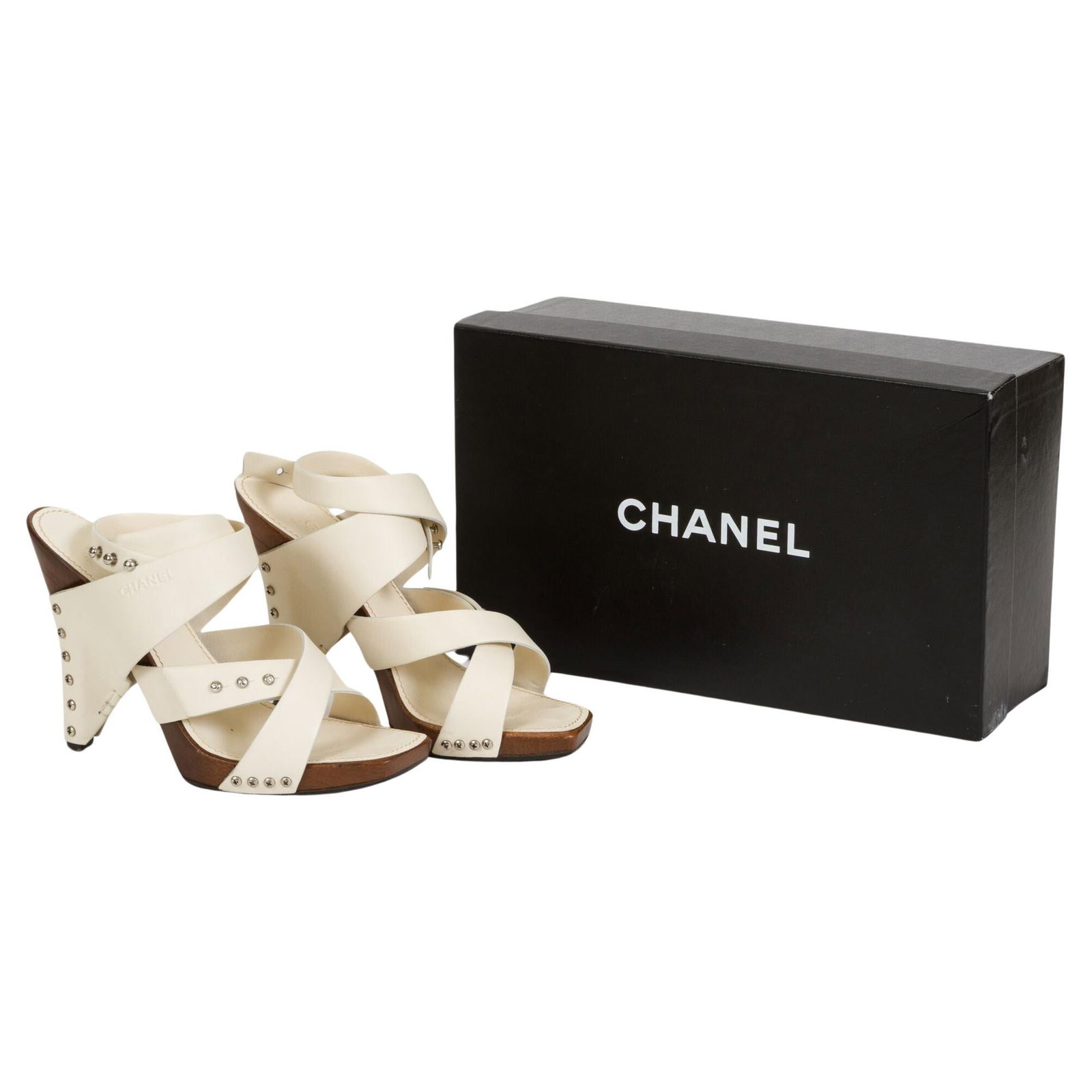 Chanel Cream Lambskin Wood Mules Spring 2003 Size 37.5: Chanel Cream Lambskin Wood Mules Spring 2003 Size 37.5 Step into elegance with these Chanel cream leather and wood sandals. Crafted from high-quality lambskin, these mules are part of the exclusive Sp