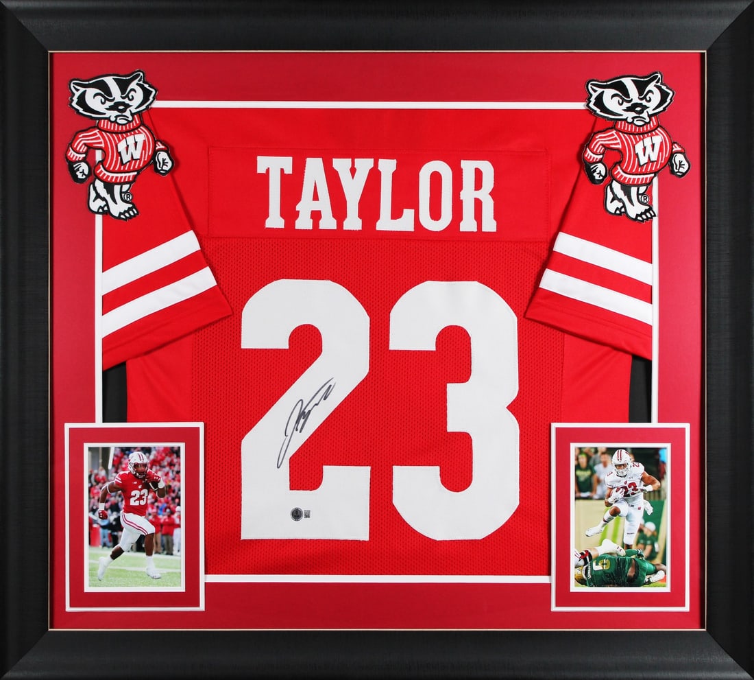 Framed Wisconsin Badgers Red Jersey Signed by Jonathan Taylor Beckett Authenticated: Framed Wisconsin Badgers Red Jersey Signed by Jonathan Taylor Beckett Authenticated This is a red pro style framed jersey personally signed by Jonathan Taylor of the Wisconsin Badgers. The autograph i