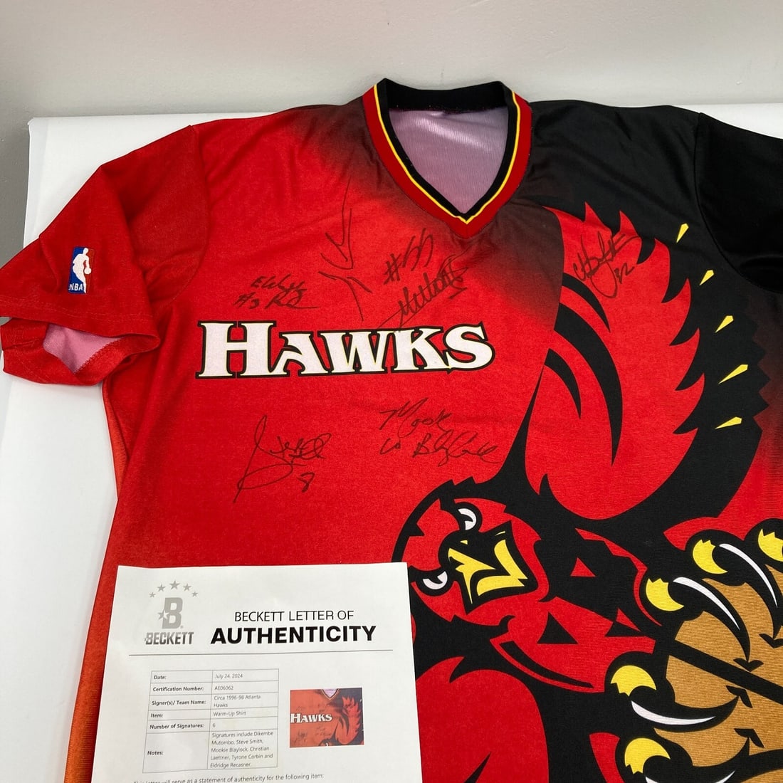 Dikembe Mutombo Multi Signed Atlanta Hawks Shooting Shirt Beckett Authenticated: Dikembe Mutombo Multi Signed Atlanta Hawks Shooting Shirt Beckett Authenticated This original Atlanta Hawks shooting shirt, produced by Champion, is a unique collectible featuring the signatures of si