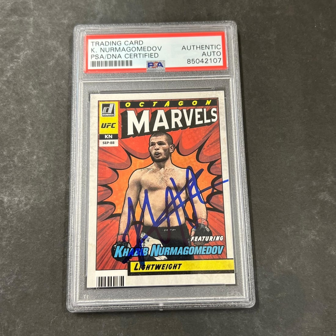 Khabib Nurmagomedov PSA Autographed Panini Octagon Marvels Card 11: Khabib Nurmagomedov PSA Autographed Panini Octagon Marvels Card 11 This is a 2022 Panini Octagon Marvels #11 sports trading card featuring Khabib Nurmagomedov. The card is from the 2022 Donruss UFC se