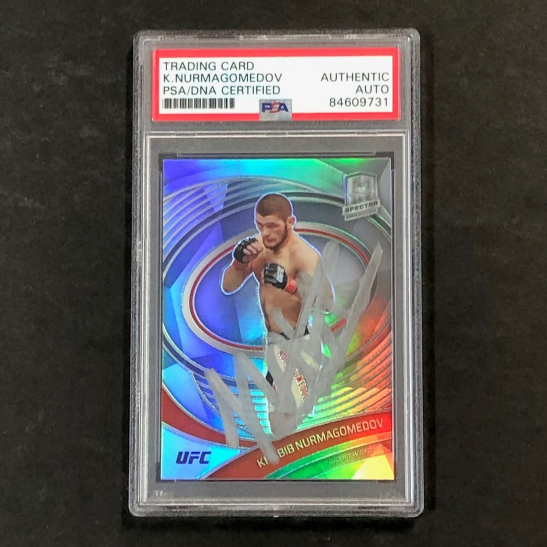 2021 Panini Chronicles Spectra Khabib Nurmagomedov Signed Card PSA 10: 2021 Panini Chronicles Spectra Khabib Nurmagomedov Signed Card PSA 10 This is a 2021 Panini Chronicles Spectra trading card featuring a signature from MMA star Khabib Nurmagomedov. The card, numbered 