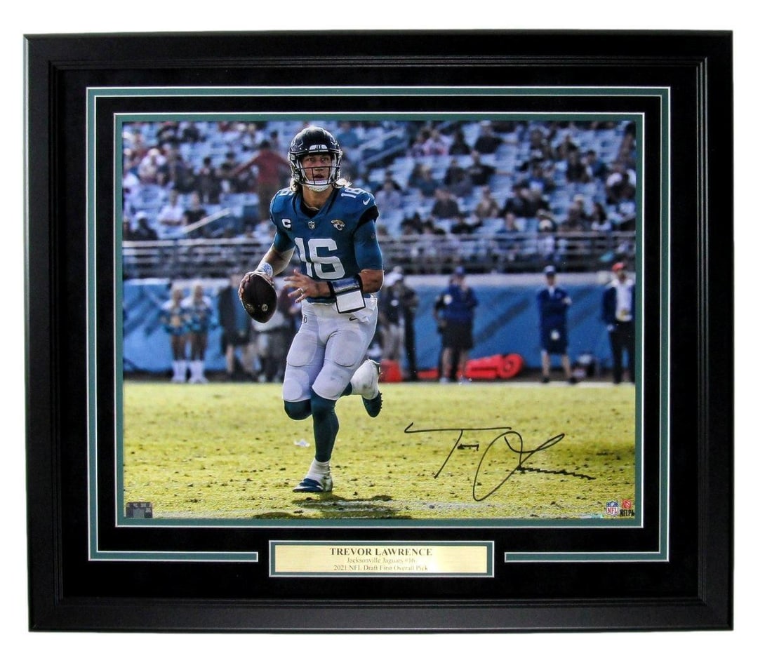 Framed 16x20 Jacksonville Jaguars Photo Signed by Trevor Lawrence Fanatics Authenticated: Framed 16x20 Jacksonville Jaguars Photo Signed by Trevor Lawrence Fanatics Authenticated This framed 16x20 photo features the autograph of Trevor Lawrence, quarterback for the Jacksonville Jaguars. Th