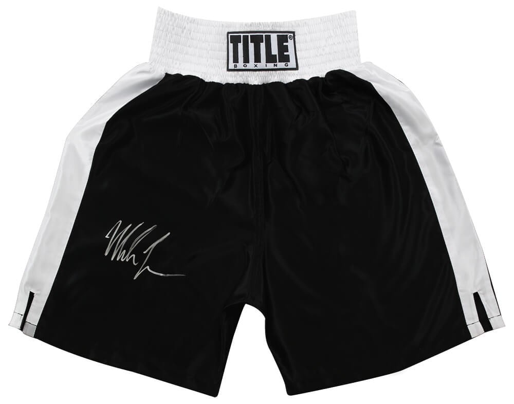 Mike Tyson Signed Title Boxing Trunks with COA Black White Trim: Mike Tyson Signed Title Boxing Trunks with COA Black White Trim Own a piece of boxing history with these Mike Tyson signed Title boxing trunks featuring a sleek black design with white trim. This orig