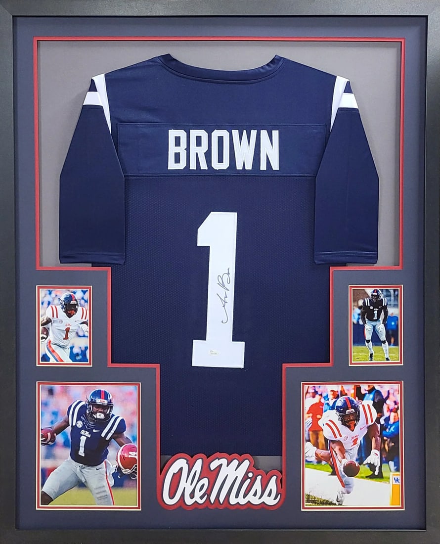 Framed Ole Miss Blue Jersey Signed by AJ Brown with Beckett Authentication: Framed Ole Miss Blue Jersey Signed by AJ Brown with Beckett Authentication This framed Ole Miss blue jersey is autographed by A.J. Brown and authenticated by Beckett. The display features detailed fra