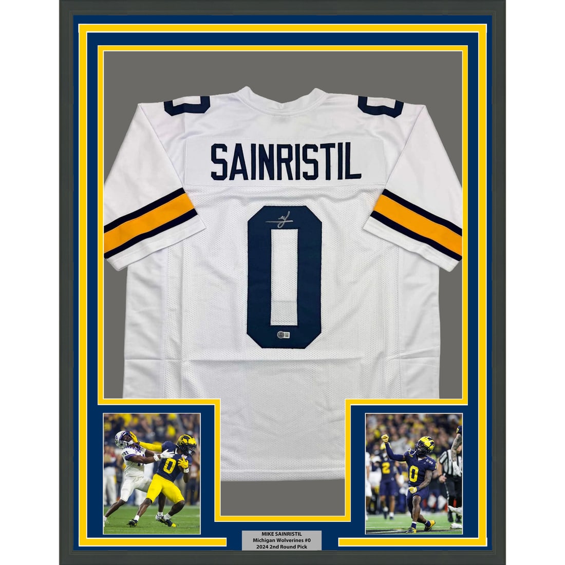 Mike Sainristil Signed Michigan Jersey Framed Display 35x39 With Beckett COA: Mike Sainristil Signed Michigan Jersey Framed Display 35x39 With Beckett COA This professionally framed and matted display features a Michigan Wolverines white jersey autographed by Mike Sainristil. T