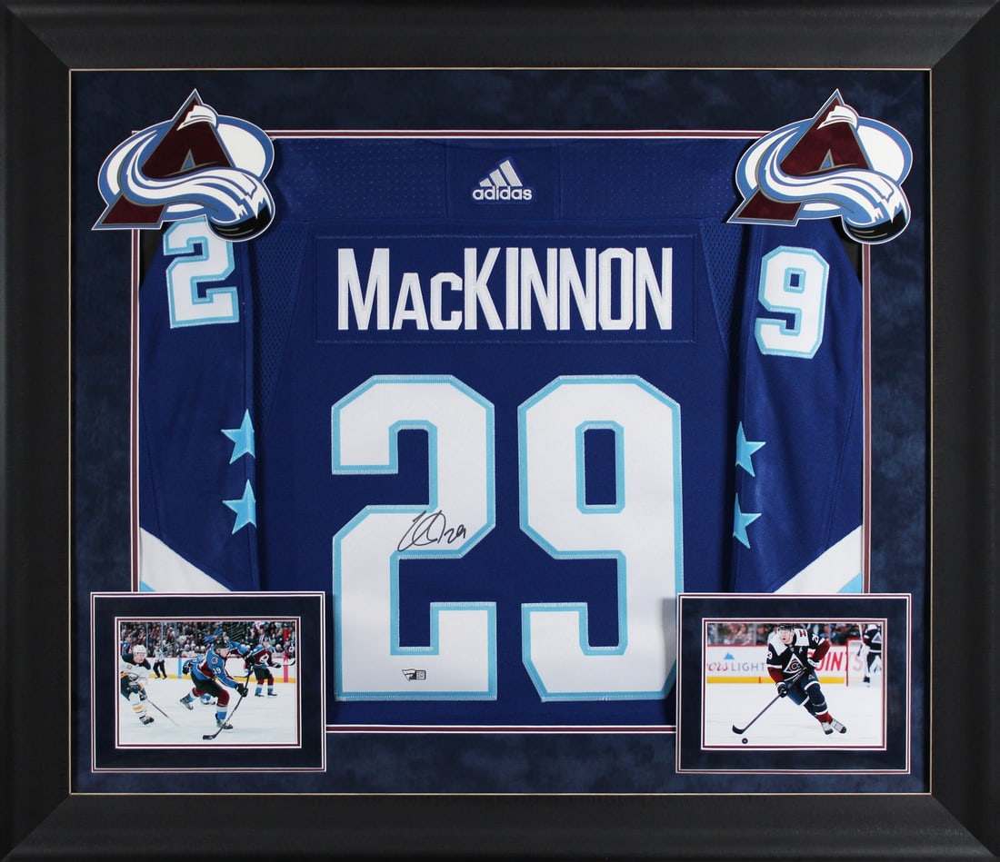 Nathan MacKinnon Signed Blue Adidas ASG Jersey Framed with Fight Strap: Nathan MacKinnon Signed Blue Adidas ASG Jersey Framed with Fight Strap This framed jersey showcases Nathan MacKinnon's signature and is a must-have for fans of the Colorado Avalanche. The blue Adidas 
