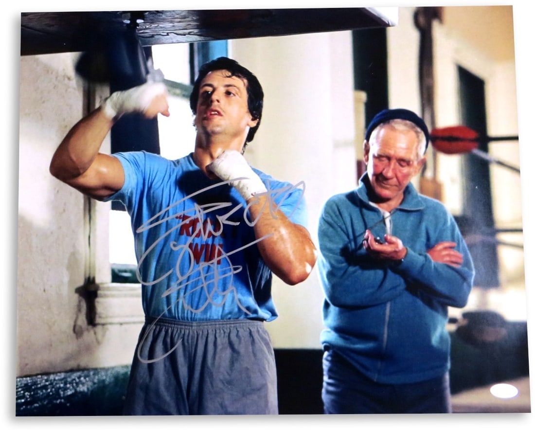 Sylvester Stallone Autographed 16x20 Rocky Photo JSA Certified: Sylvester Stallone Autographed 16x20 Rocky Photo JSA Certified This impressive 16x20 photograph features Sylvester Stallone, famously known for his role as Rocky, showcasing his signature in bold ink.