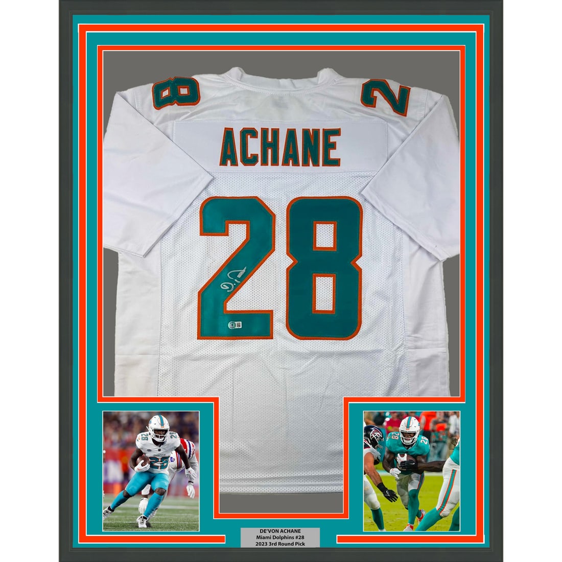 Framed DeVon Achane signed Miami Dolphins white jersey BAS COA: Framed DeVon Achane signed Miami Dolphins white jersey BAS COA This professionally framed and matted display features a De'Von Achane Miami Dolphins white jersey, autographed by the athlete. The frame