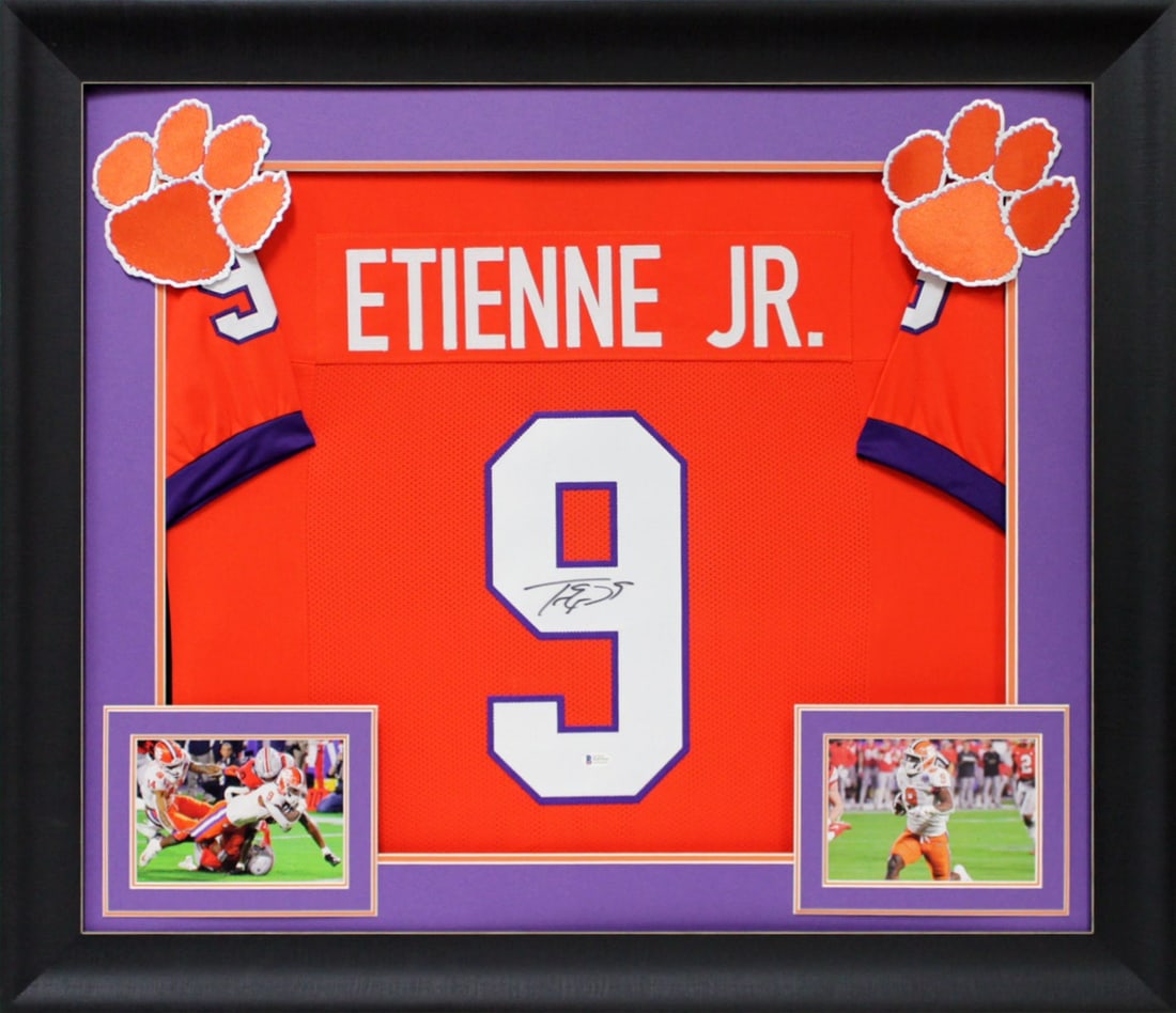Travis Etienne Signed Orange Pro Style Framed Jersey Clemson BAS: Travis Etienne Signed Orange Pro Style Framed Jersey Clemson BAS Capture a piece of football history with this authentic, signed orange Pro Style framed jersey from Clemson Tigers star Travis Etienne.