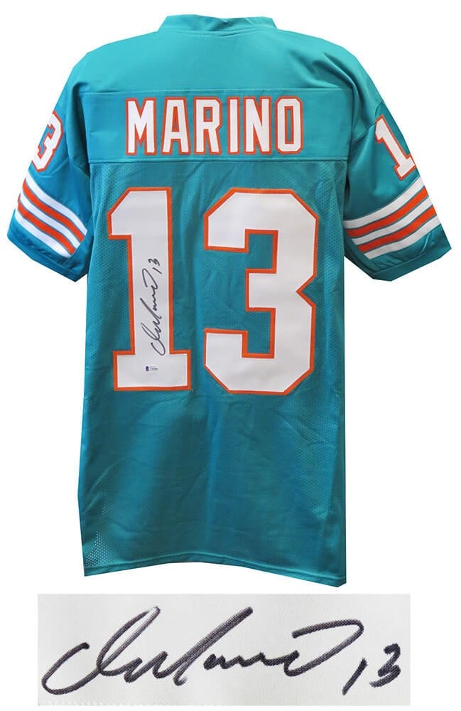 Signed Dan Marino Teal Custom Dolphins Jersey Beckett COA XL: Signed Dan Marino Teal Custom Dolphins Jersey Beckett COA XL This is a teal custom football jersey signed by Dan Marino of the Miami Dolphins. The jersey includes a Beckett Authentication tamper-evide