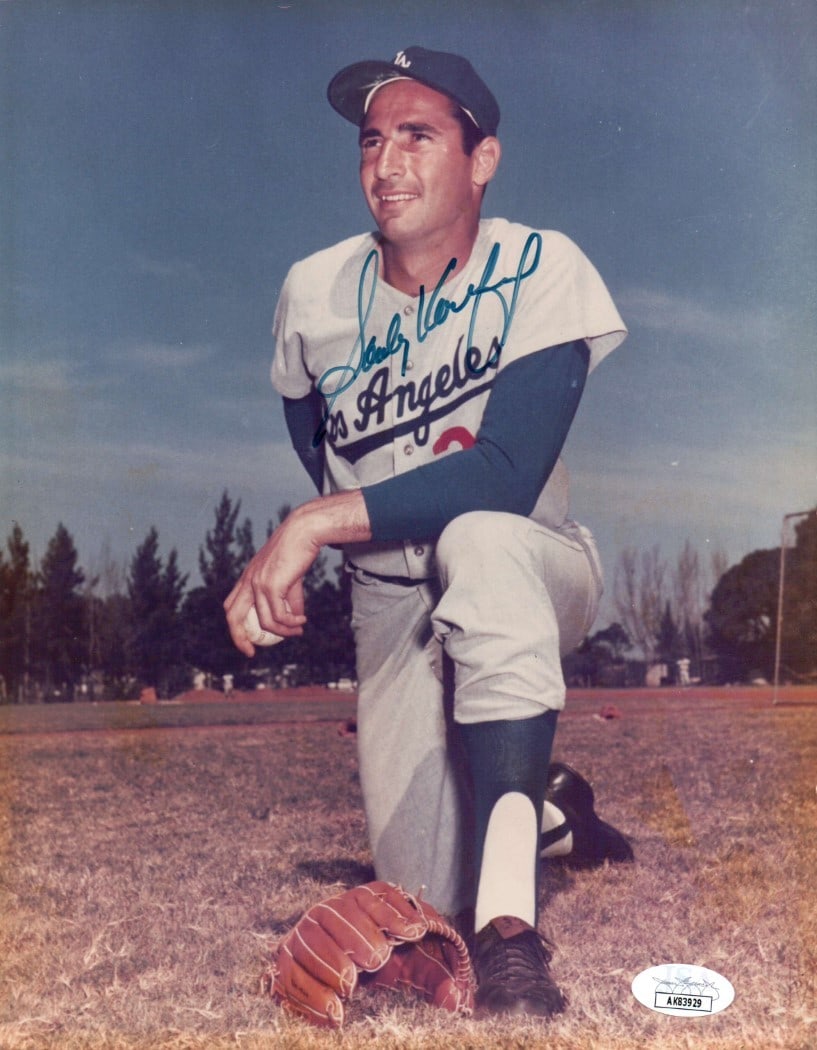 Sandy Koufax Autographed 8x10 Photo Dodgers Vintage JSA Certified: Sandy Koufax Autographed 8x10 Photo Dodgers Vintage JSA Certified This is a stunning 8X10 photo of Sandy Koufax, showcasing the legendary pitcher in a classic field pose. The photograph is an original