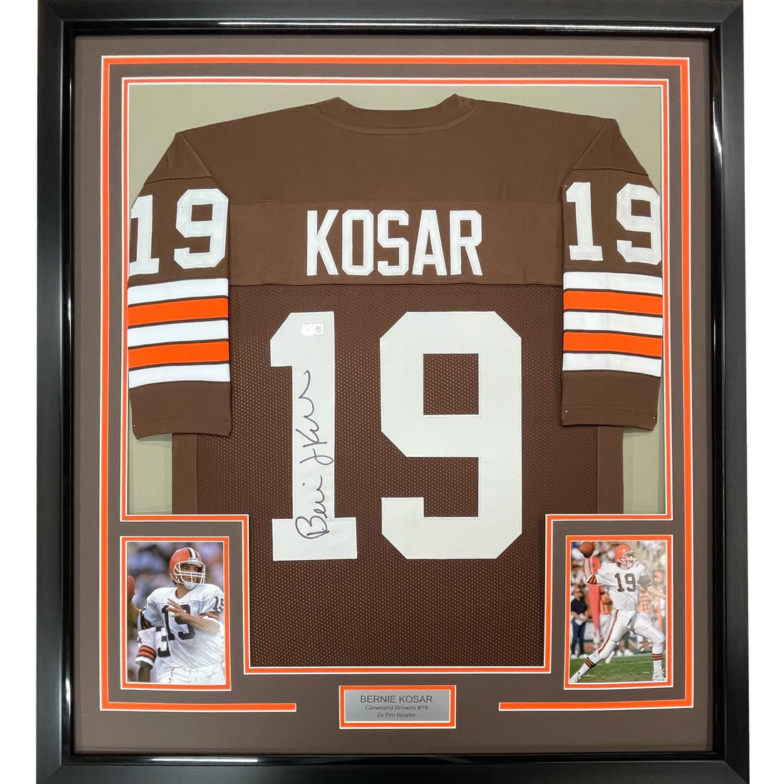 Bernie Kosar JSA Signed Framed Browns Jersey 33x42: Bernie Kosar JSA Signed Framed Browns Jersey 33x42 This professionally framed Cleveland Browns jersey features the authentic signature of Bernie Kosar. The display includes two 8x10 photographs and is