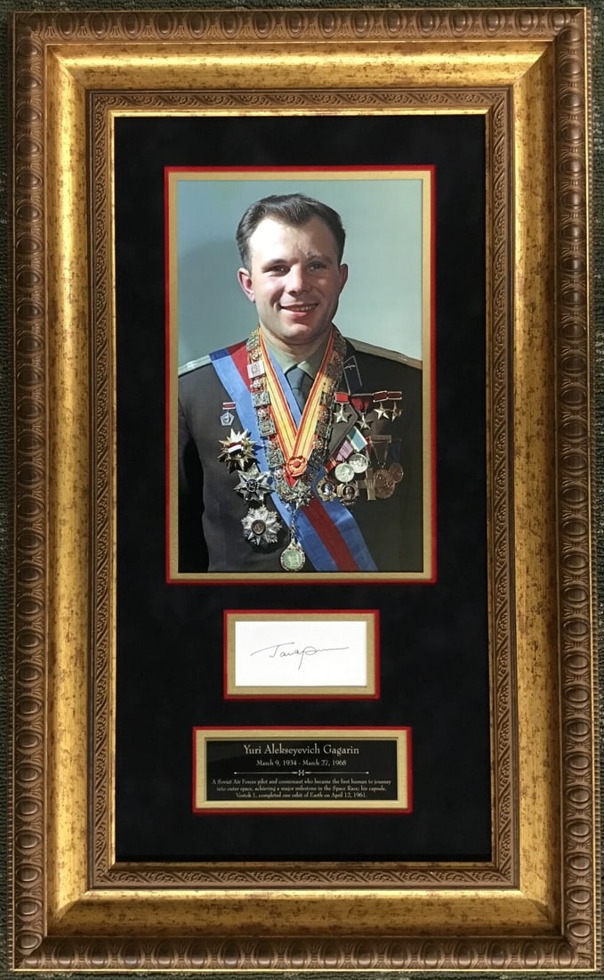 Yuri Gagarin Signed Framed Display Authenticated by John Reznikoff: Yuri Gagarin Signed Framed Display Authenticated by John Reznikoff This professionally framed display features a cut signature from Yuri Gagarin, the pioneering Russian Cosmonaut and the first human t
