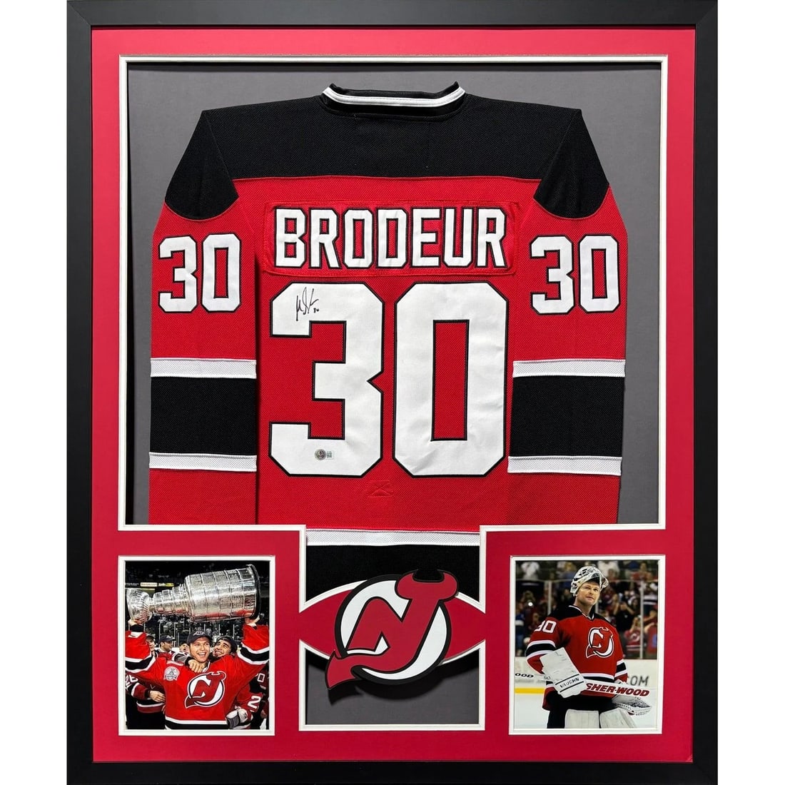 Framed Martin Brodeur Autographed Devils Jersey JSA: Framed Martin Brodeur Autographed Devils Jersey JSA This is a framed Martin Brodeur jersey autographed by the legendary goaltender of the New Jersey Devils. The jersey is authenticated by JSA and incl