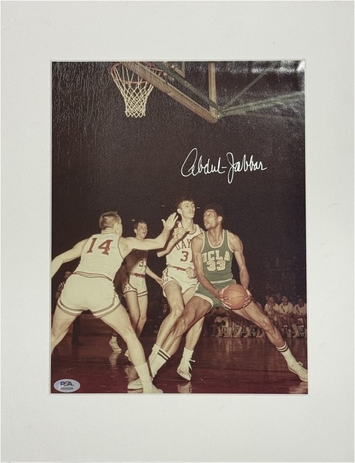12x18 Matted Photograph Signed by Kareem Abdul-Jabbar PSA Authenticated: 12x18 Matted Photograph Signed by Kareem Abdul-Jabbar PSA Authenticated This is a 12x18 matted photo autographed by Kareem Abdul-Jabbar, featuring his time with the Los Angeles Lakers. The signature i